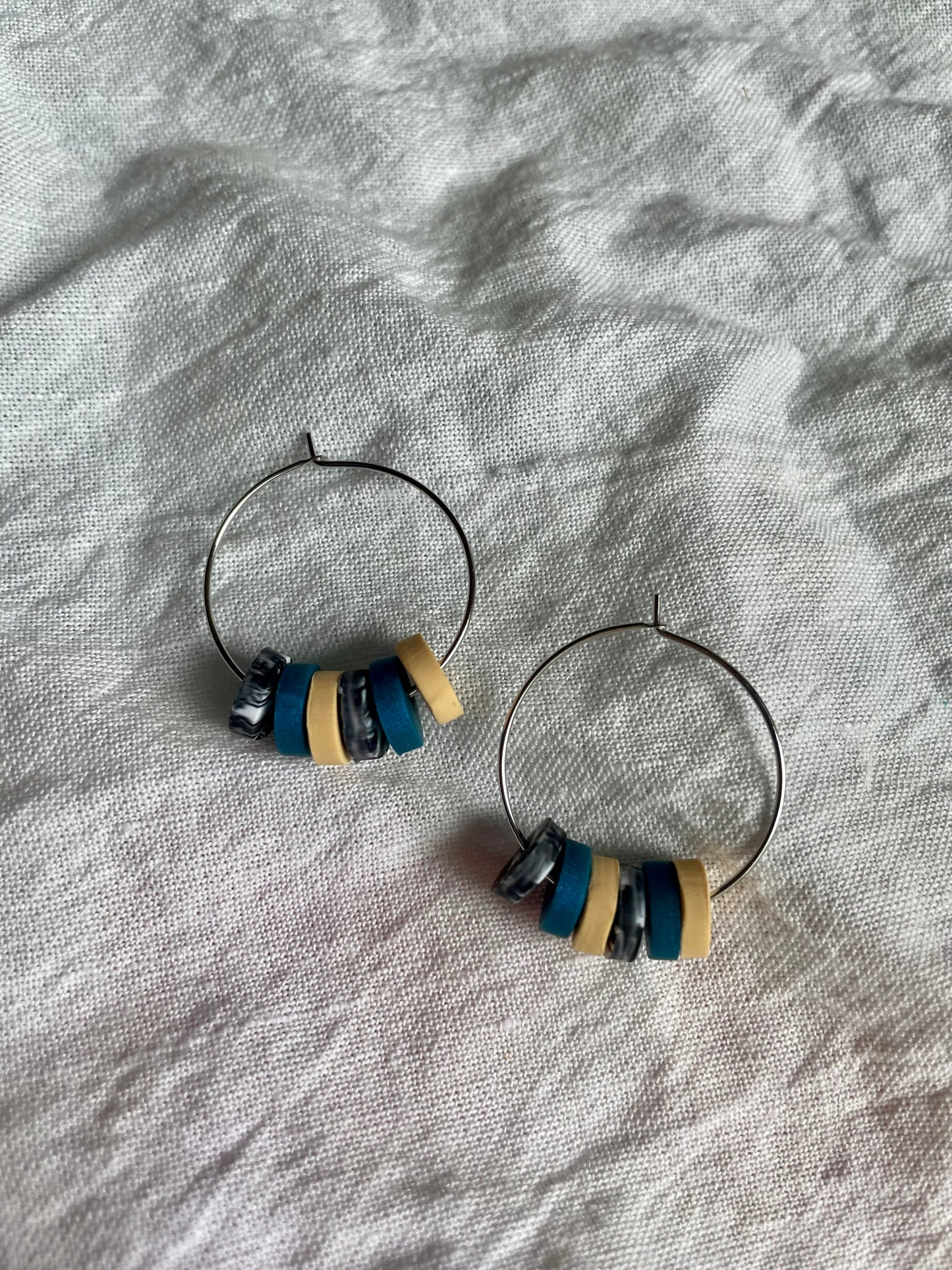 Teal, yellow, and grey swirl hoops